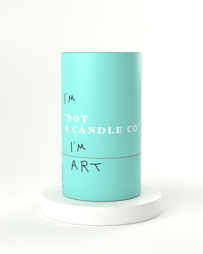 One Not A Candle Co tube on a marble plinth