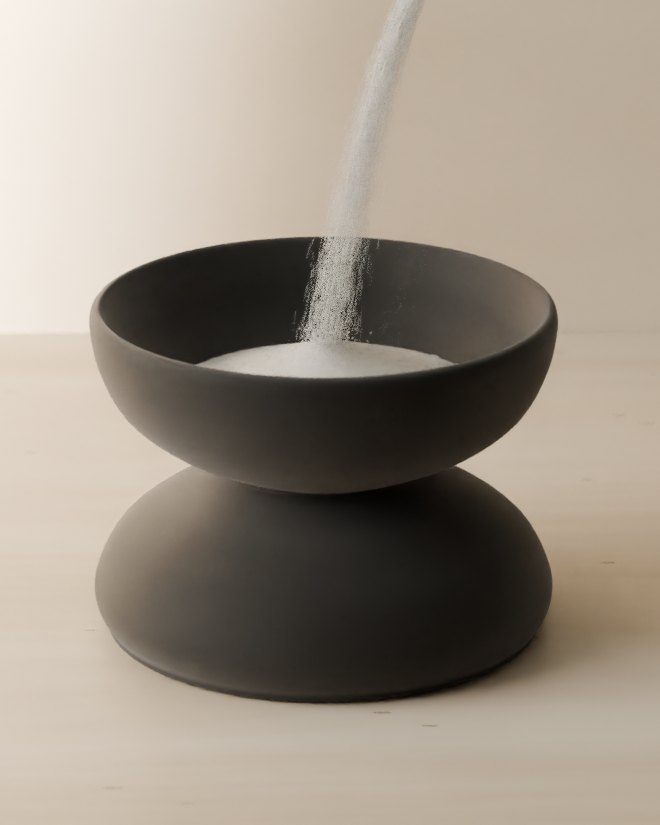 Candle pearls pouring from the tube into a bowl